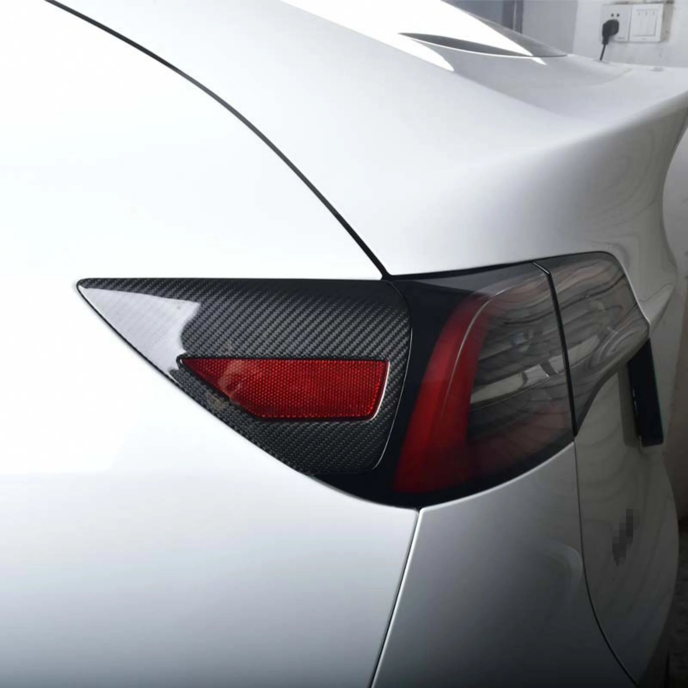 Side view of carbon fiber charging port cover for Tesla