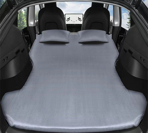 Tesla camping air mattress unfolded across rear seat and trunk