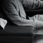 Tesla driver using suede armrest booster pad with tissue box
